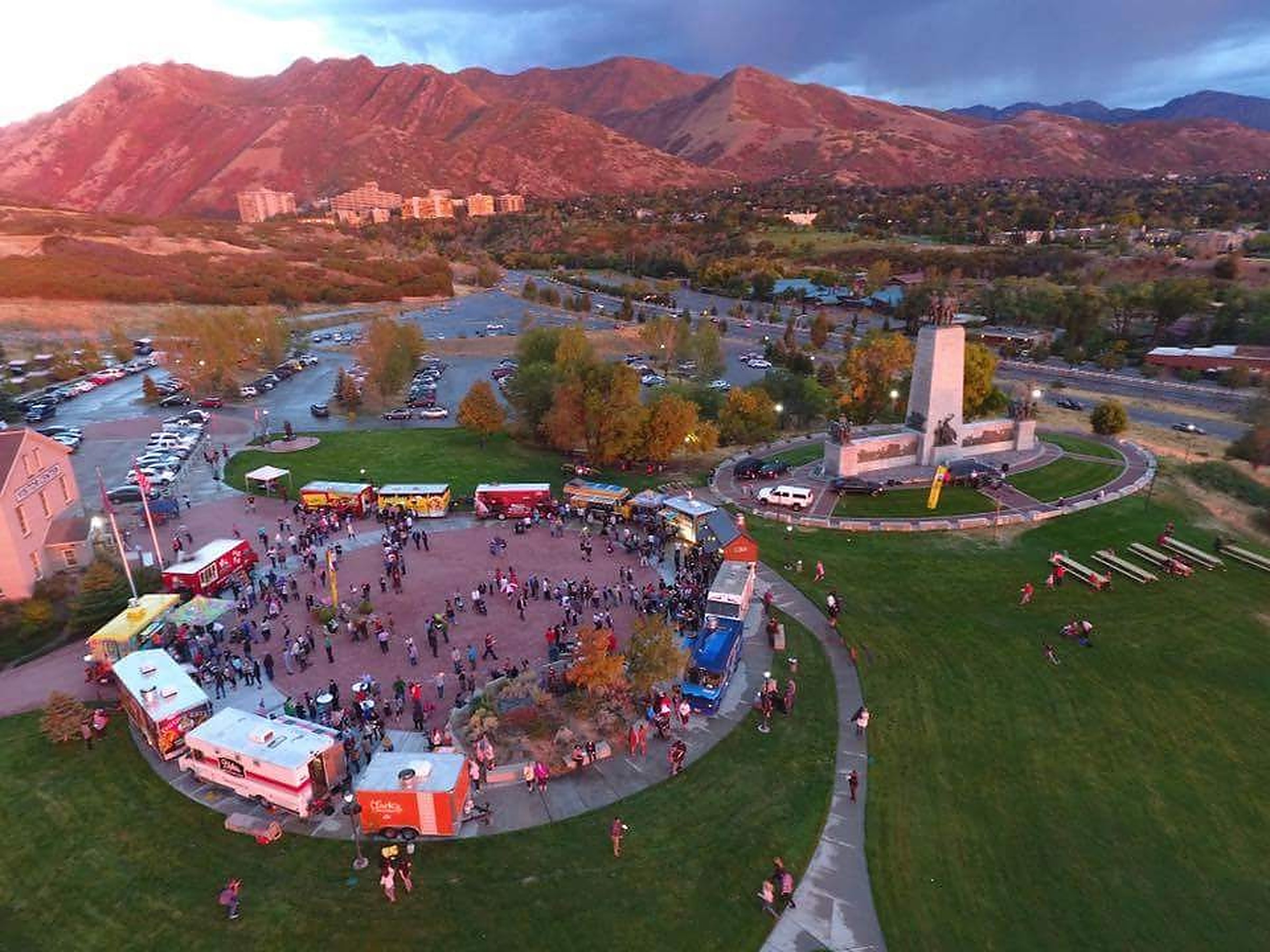 Aerial view of a food truck rally with mountains in the background